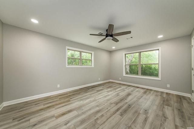 spare room with a ceiling fan, visible vents, light wood-type flooring, baseboards, and recessed lighting
