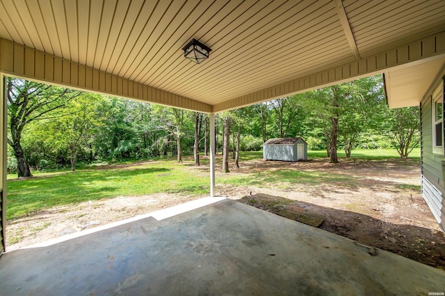 view of patio / terrace featuring an outdoor structure and a shed