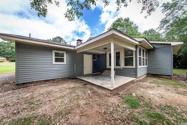 back of property with a patio