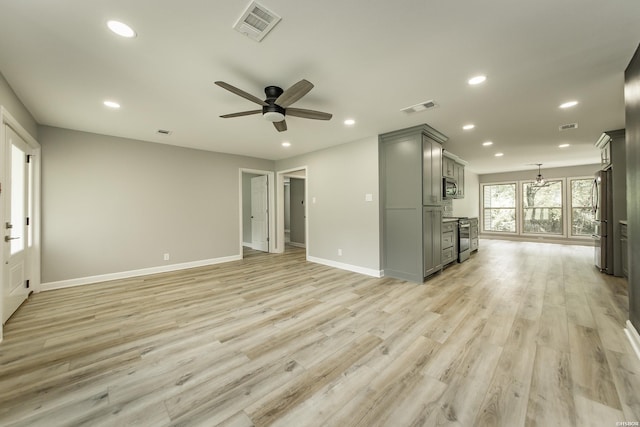 unfurnished living room with recessed lighting and visible vents