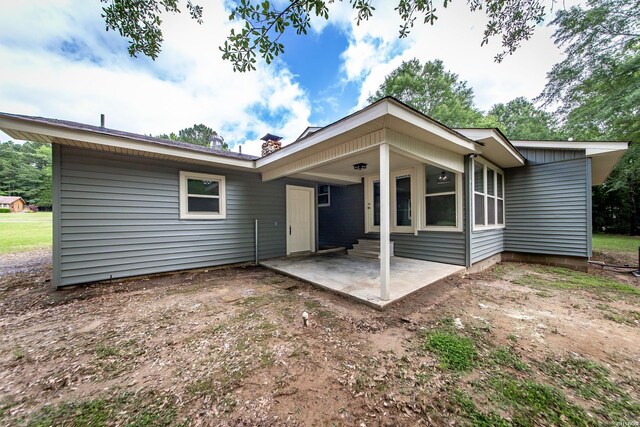 back of property with a patio