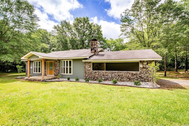 ranch-style home featuring a chimney, a front lawn, stone siding, and a porch