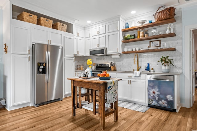 126 Chambers Pt Unit E, Hot Springs, AR 71913 - kitchen featuring a sink, stainless steel appliances, open shelves, tasteful backsplash, and white cabinetry