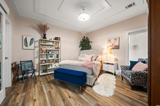 126 Chambers Pt Unit E, Hot Springs, AR 71913 - bedroom featuring a raised ceiling, wood finished floors, and visible vents