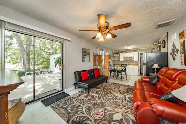 358 Buccaneer St, Hot Springs, AR 71913 - living room featuring ceiling fan, a textured ceiling, and light flooring