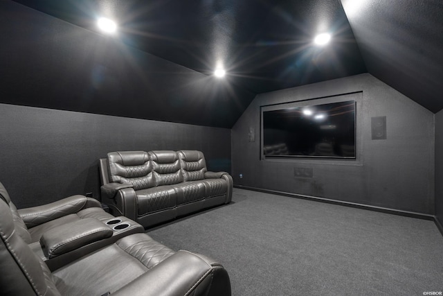 home theater featuring vaulted ceiling, carpet flooring, and baseboards