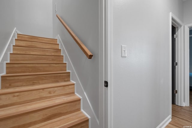 stairway with wood finished floors