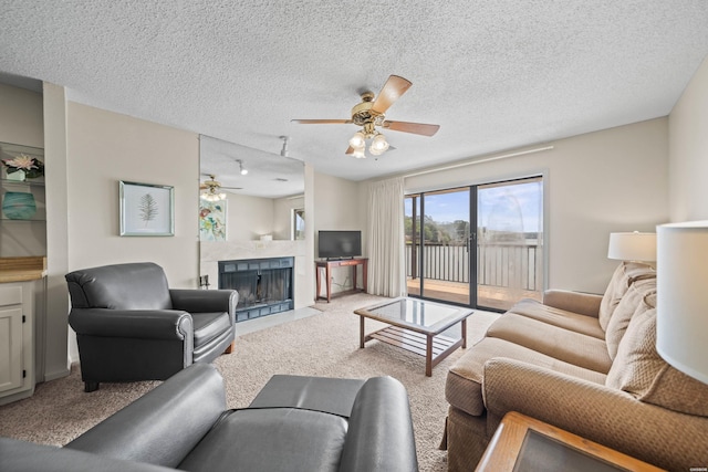 5371 Central Ave Unit 6H, Hot Springs, AR 71913 - living area with ceiling fan, a fireplace, light carpet, and a textured ceiling