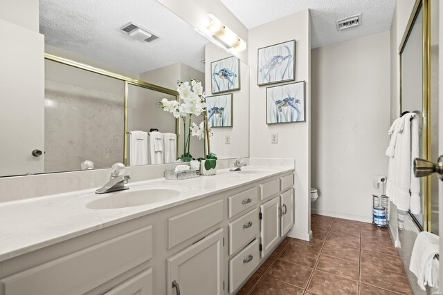 5371 Central Ave Unit 6H, Hot Springs, AR 71913 - full bathroom with double vanity, a textured ceiling, a shower with shower door, and tile patterned floors