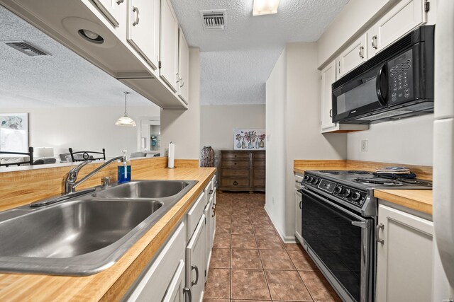 5371 Central Ave Unit 6H, Hot Springs, AR 71913 - kitchen featuring black appliances, butcher block counters, a textured ceiling, white cabinets, and dark tile patterned flooring