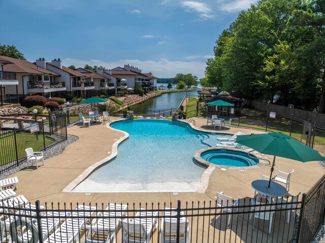 5371 Central Ave Unit 6H, Hot Springs, AR 71913 - view of pool featuring a patio area, a pool with connected hot tub, a water view, and a residential view