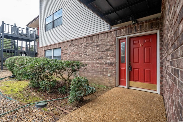 doorway to property with brick siding