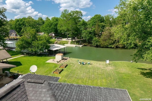 surrounding community with a yard and a water view