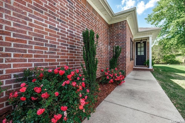 property entrance featuring brick siding