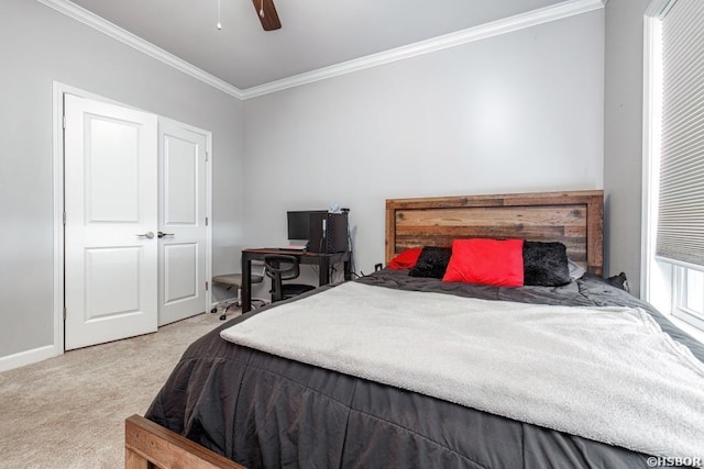 carpeted bedroom featuring ceiling fan, baseboards, and crown molding