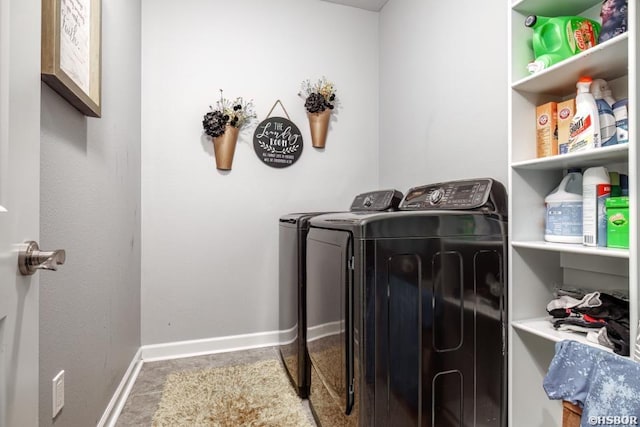 laundry room featuring laundry area, baseboards, and washing machine and clothes dryer