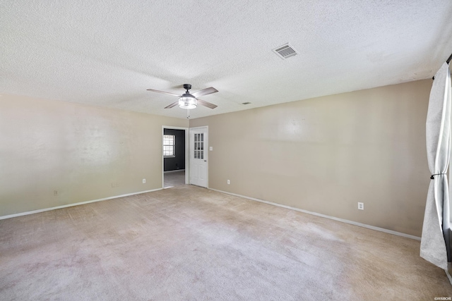 711 S Red St, Sheridan, AR 72150 - spare room featuring light carpet, a textured ceiling, visible vents, baseboards, and a ceiling fan