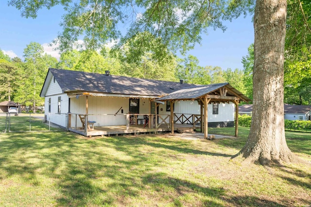 711 S Red St, Sheridan, AR 72150 - rear view of house with a gate, a lawn, fence, and a deck