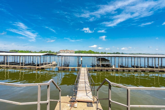 dock area with boat lift and a water view