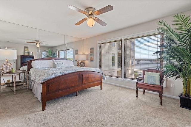 bedroom with baseboards, light carpet, and ceiling fan