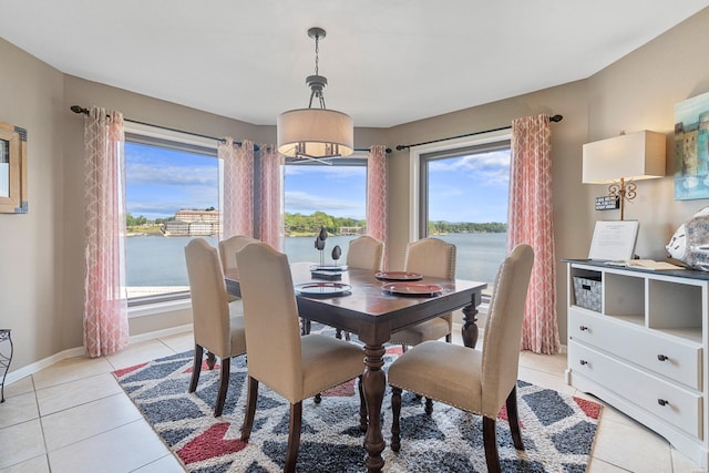 dining area featuring plenty of natural light, baseboards, and light tile patterned floors