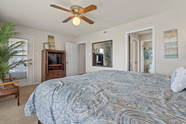 carpeted bedroom with ceiling fan, visible vents, access to exterior, and ensuite bathroom