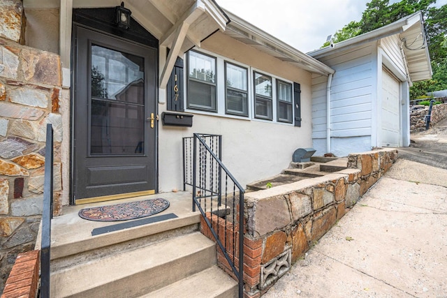 property entrance featuring stucco siding