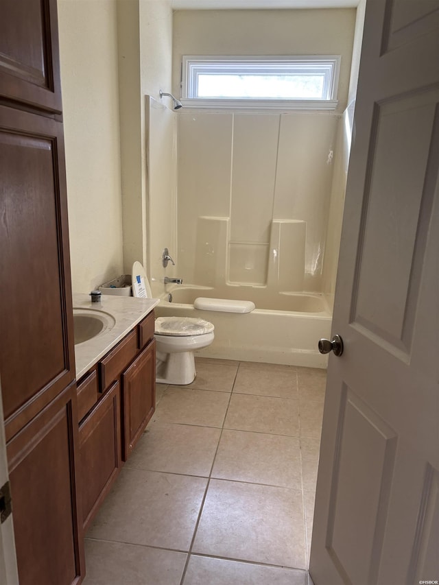 bathroom featuring washtub / shower combination, vanity, tile patterned flooring, and toilet