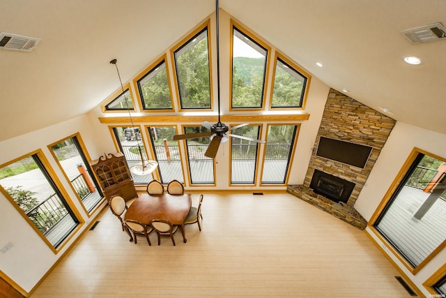 415 Gold Nugget Loop, Hot Springs, AR 71913 - dining area with high vaulted ceiling, plenty of natural light, a stone fireplace, hardwood / wood-style floors, and a ceiling fan