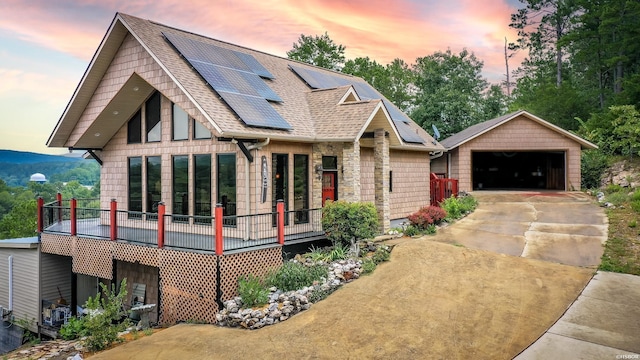 415 Gold Nugget Loop, Hot Springs, AR 71913 - view of front of house with solar panels, roof with shingles, an outbuilding, and a detached garage