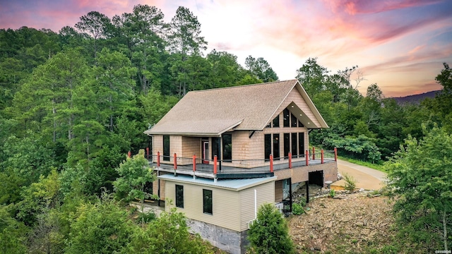 415 Gold Nugget Loop, Hot Springs, AR 71913 - back of property with a forest view and roof with shingles
