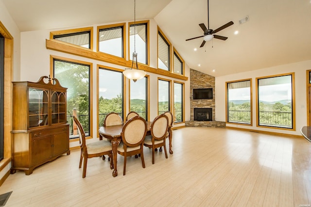 415 Gold Nugget Loop, Hot Springs, AR 71913 - dining space featuring healthy amount of natural light, high vaulted ceiling, ceiling fan, a stone fireplace, and light wood-style floors