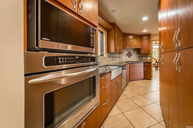 415 Gold Nugget Loop, Hot Springs, AR 71913 - kitchen with appliances with stainless steel finishes, tasteful backsplash, light tile patterned floors, brown cabinets, and recessed lighting
