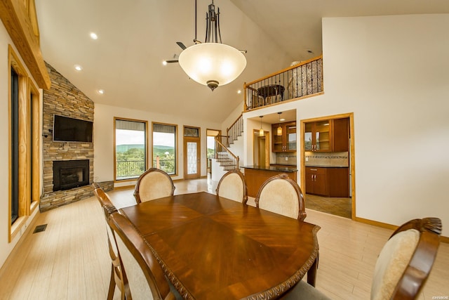 415 Gold Nugget Loop, Hot Springs, AR 71913 - dining area featuring high vaulted ceiling, stairs, a stone fireplace, and recessed lighting