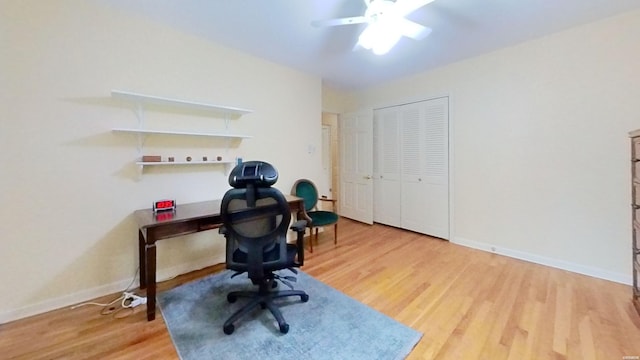 office space featuring ceiling fan, baseboards, and wood finished floors