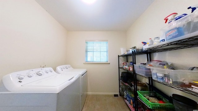 washroom with laundry area, light tile patterned floors, baseboards, and washer and dryer