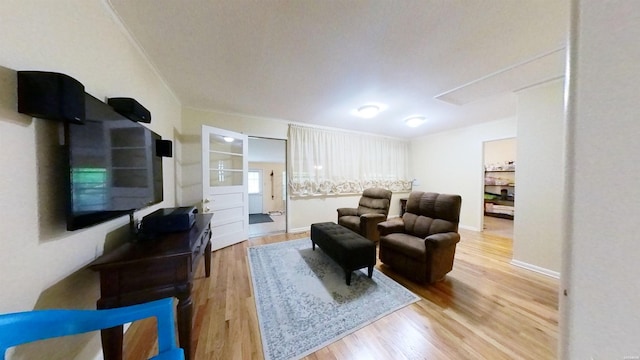 living room featuring light wood-type flooring and baseboards