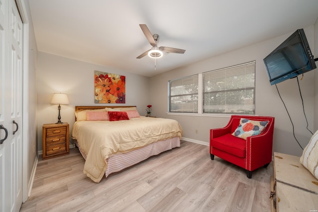 bedroom with light wood-style floors, ceiling fan, and baseboards