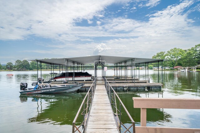 dock area with a water view and boat lift