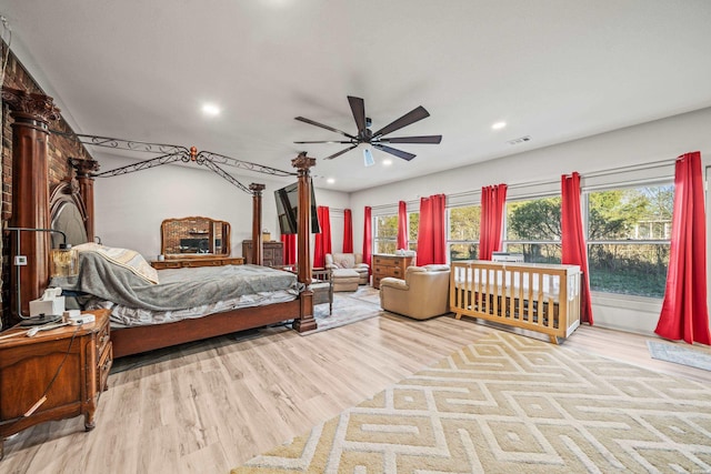 bedroom with wood finished floors, visible vents, and recessed lighting