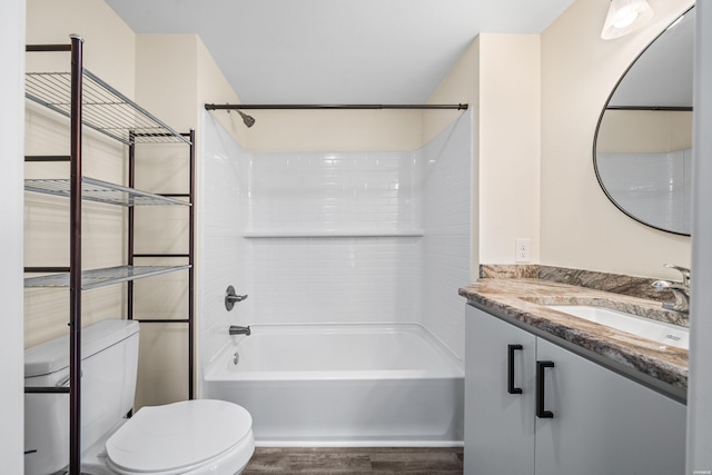 bathroom featuring toilet, vanity, and bathing tub / shower combination