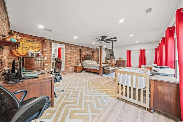 bedroom with brick wall, visible vents, wood finished floors, and recessed lighting