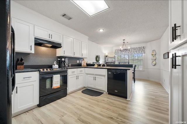 200 Cole Pl, Hot Springs, AR 71901 - kitchen featuring black appliances, under cabinet range hood, a peninsula, a textured ceiling, and white cabinetry