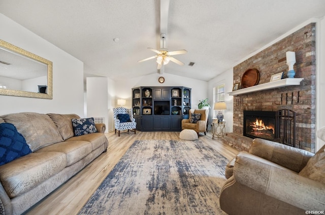 200 Cole Pl, Hot Springs, AR 71901 - living room featuring light wood-type flooring, a fireplace, ceiling fan, and a textured ceiling