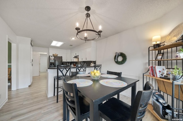 200 Cole Pl, Hot Springs, AR 71901 - dining room with a chandelier, a textured ceiling, and light wood-style floors