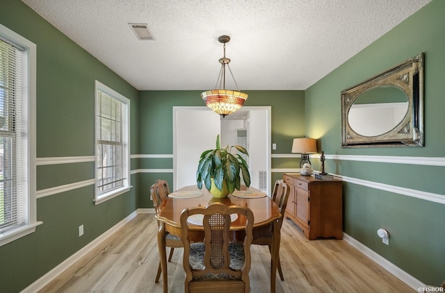200 Cole Pl, Hot Springs, AR 71901 - dining space with wood finished floors, plenty of natural light, and a textured ceiling
