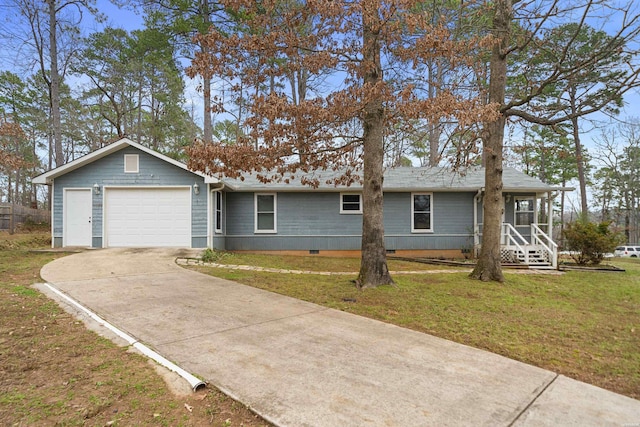 ranch-style home featuring an attached garage, concrete driveway, and a front yard