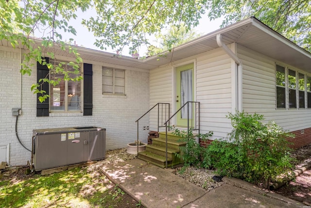 exterior space featuring central AC and brick siding