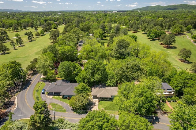 bird's eye view with a view of trees and view of golf course