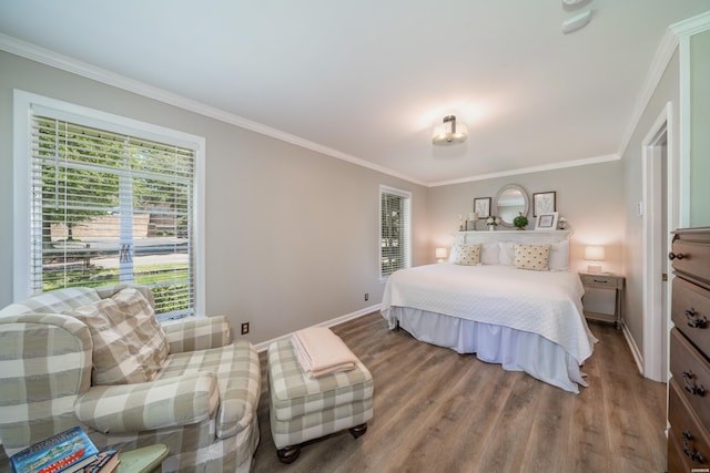 bedroom with wood finished floors, crown molding, and baseboards